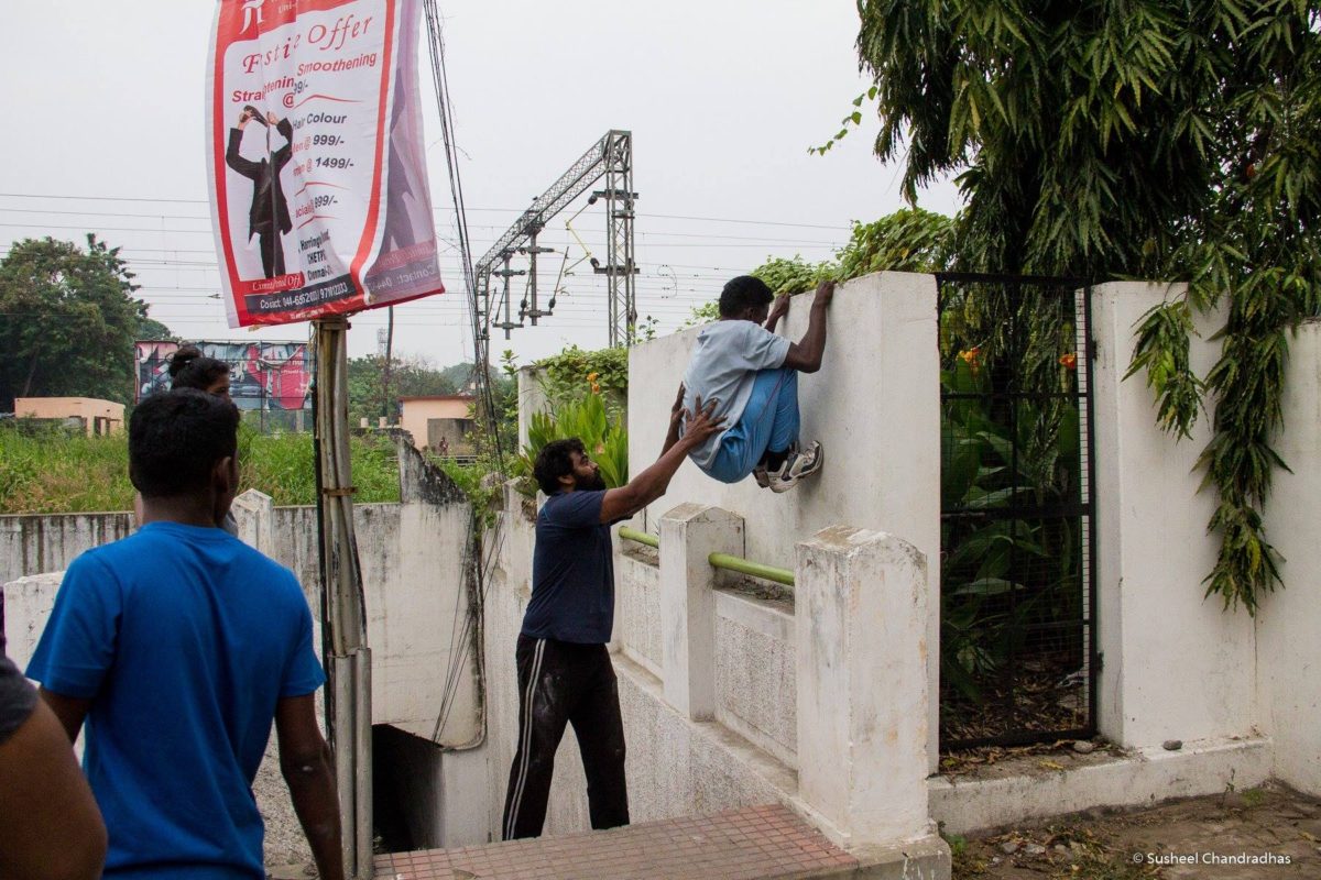 Prabu guiding a student to climb a wall during a recent parkour session on harrington road in chennai.